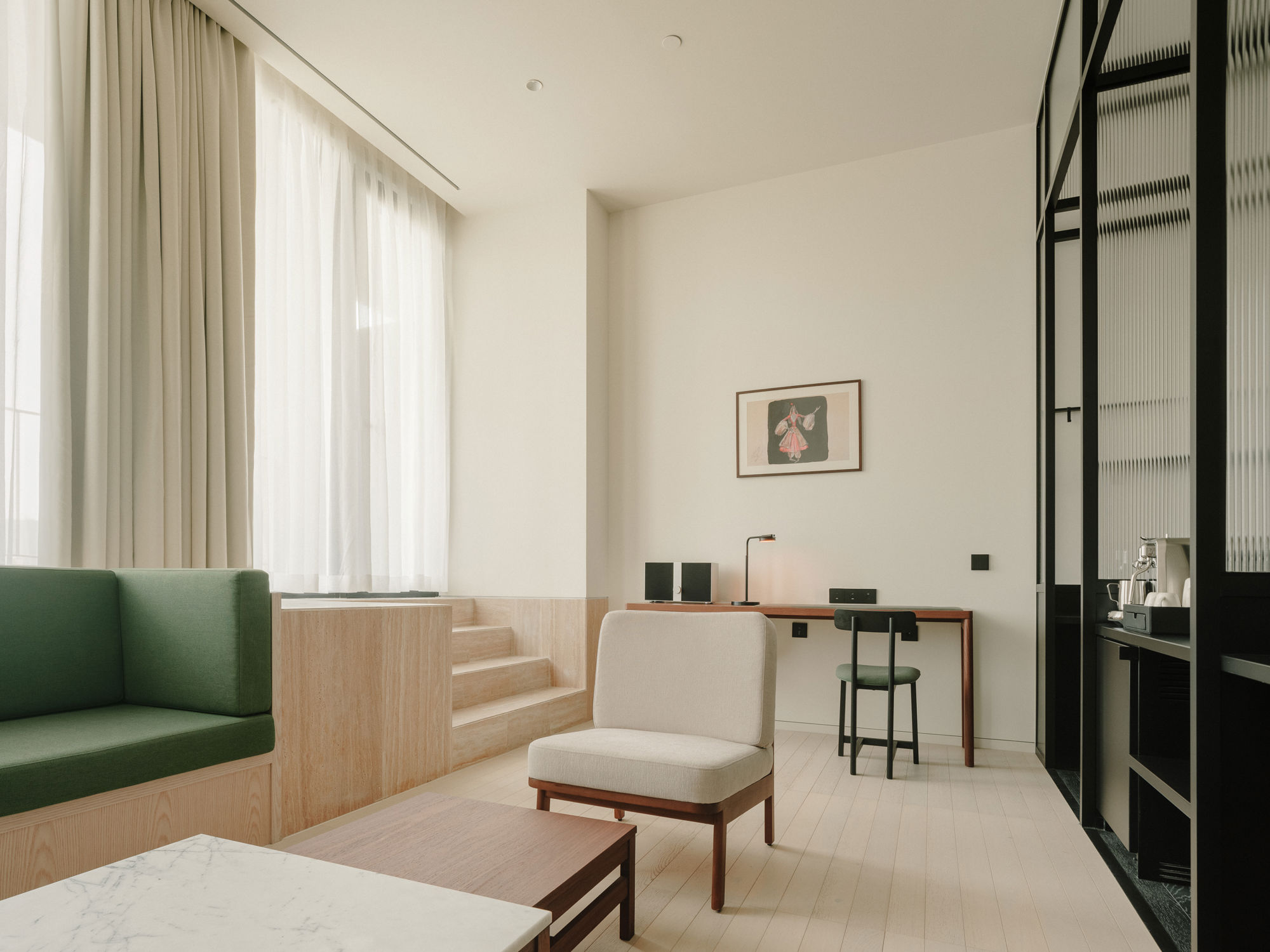 Minimalist luxury suite featuring bespoke furniture and curated art pieces.