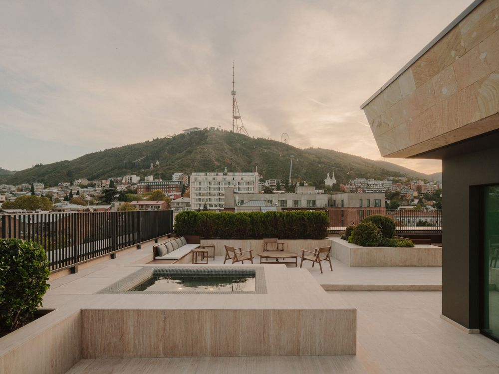 Telegraph Hotel suite showing floor-to-ceiling glass and terrace access.