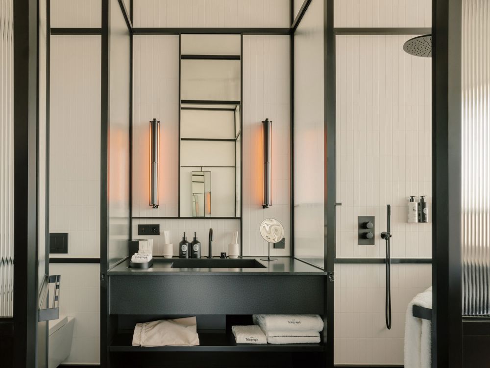 Spacious walk-in shower with grey slate tiles and a built-in bench.